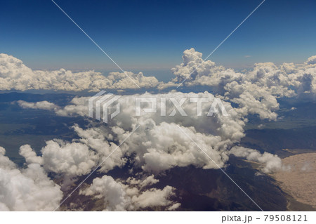 Aerial view of Arizona mountains landscape in fluffy clouds from airplane the window Aerial view of Arizona mountains landscape in fluffy clouds from airplane the window 79508121