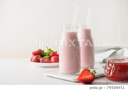 Indian strawberry lassi or milkshake in bottle on white . 79508451