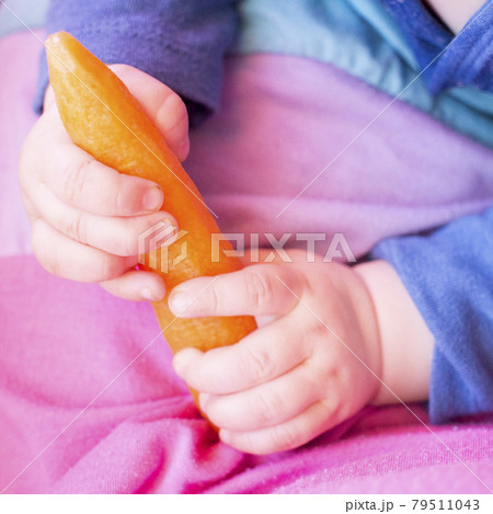 a child plays with a carrot 79511043