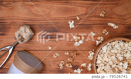 Popcorn bowl and ice cream and on wooden background. 79526741