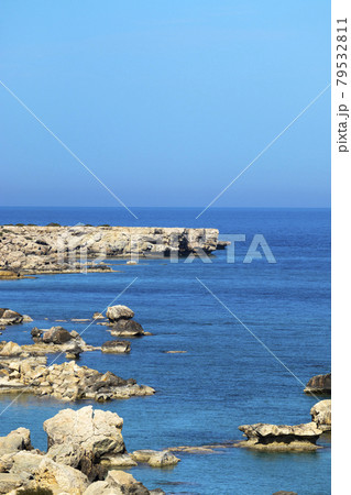 Mediterranean sea beach. Stones and Rocks. Summer day seascape. Clear Water texture. Aerial view, sunny day over sea or ocean. Vertical Photo. Nature wallpaper. 79532811