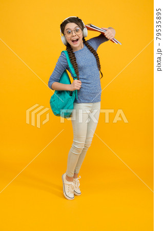 Welcome back to school. Happy child carry backpack yellow background. Welcome back to school. Happy child carry backpack yellow background. 79535895