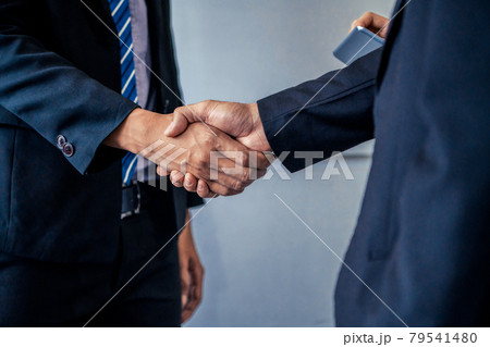 Business people handshake agreement in office. 79541480