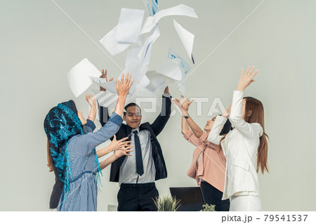 Business people throwing papers in the office. Business people throwing papers in the office. 79541537