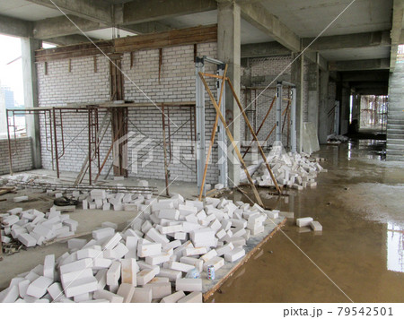 JASIN, MALAYSIA -SEPTEMBER 09, 2016: Brick walling joint and workmanship under construction at the construction site. Clay brick was attached together using cement mortar. JASIN, MALAYSIA -SEPTEMBER 09, 2016: Brick walling joint and workmanship under construction at the construction site. Clay brick was attached together using cement mortar. 79542501
