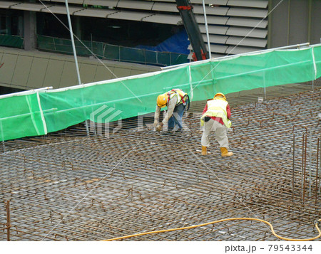 MALACCA, MALAYSIA -SEPTEMBER 24, 2016: Construction workers fabricating floor slab reinforcement bar at the construction site in Malacca, Malaysia.   79543344