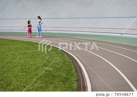 Couple of friends standing and having conversation Couple of friends standing and having conversation 79548677