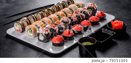 Delicious fresh rolls in various sets. Japanese food with avocado, shrimp, crab and salmon 79551303