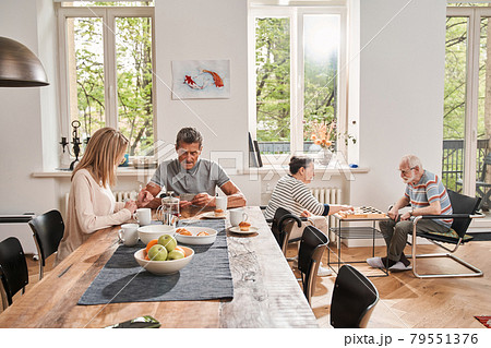 Man drinking tea with his caregiver at the nurse house 79551376