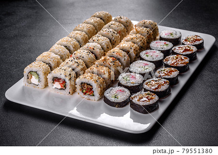 Delicious fresh rolls in various sets. Japanese food with avocado, shrimp, crab and salmon 79551380