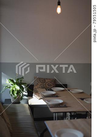 cozy place. a table inside an Italian restaurant with serving plates, knives and forks cozy place. a table inside an Italian restaurant with serving plates, knives and forks 79551505