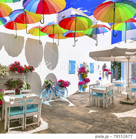 Charming bar decoration design in retro style with old bicycle,umbrellas and flowers Charming bar decoration design in retro style with old bicycle,umbrellas and flowers 79552677