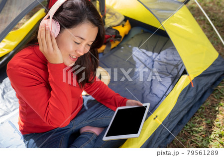 Women listening to music camping tent. Women listening to music camping tent. 79561289