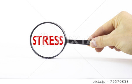 Stop stress and be health symbol. Magnifying glass with word stress on a beautiful white background. Doctor hand. Psychological, business and stop stress concept. Copy space. Stop stress and be health symbol. Magnifying glass with word stress on a beautiful white background. Doctor hand. Psychological, business and stop stress concept. Copy space. 79570353