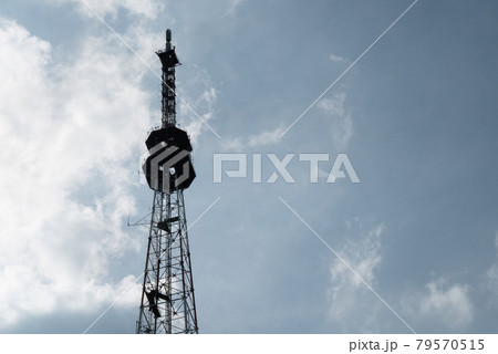 silhouette TV signal transmission and communication towers against the background of a cloudy sky 79570515