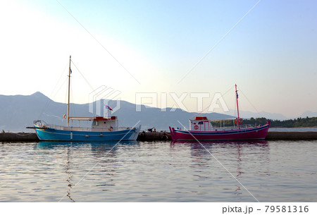 Boats on the water - Corfu Kerkyra town and blue sky at sunny day. Vacation concept in Anemomilos district, Corfu Island, Ionian islands, Greece. Empty island of Corfu. Boats on the water - Corfu Kerkyra town and blue sky at sunny day. Vacation concept in Anemomilos district, Corfu Island, Ionian islands, Greece. Empty island of Corfu. 79581316