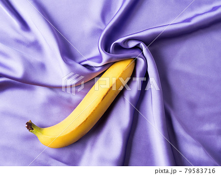 Sexy concept with banana on crumpled silk sheet 79583716
