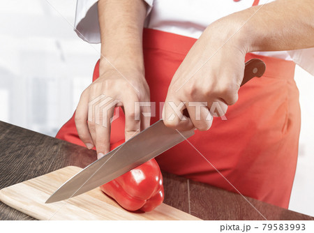 Chef hands cutting red fresh pepper Chef hands cutting red fresh pepper 79583993