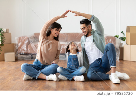 Happy parents making symbolic roof of hands above their daughter Happy parents making symbolic roof of hands above their daughter 79585720