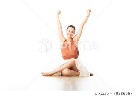 Cheerful young sporty attractive woman in bright white yoga studio, feeling exited, rising hands up in the air. Healthy active lifestyle 79586667