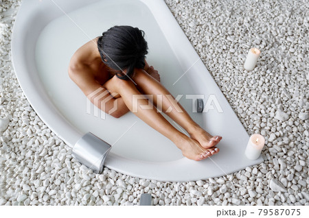 Attractive woman, relaxation in bath with milk Attractive woman, relaxation in bath with milk 79587075