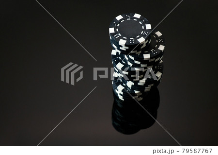 Stack of Casino gambling chips isolated on black reflective background 79587767