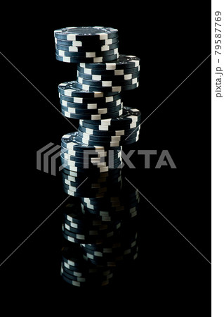 Stack of Casino gambling chips isolated on black reflective background Stack of Casino gambling chips isolated on black reflective background 79587769