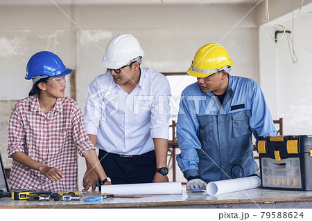 Construction engineer teamwork Safety Suit Trust Team Holding White Yellow Safety hard hat Security Equipment on Construction Site. Hardhat Protect Head for Civil Construction Engineer Concept Construction engineer teamwork Safety Suit Trust Team Holding White Yellow Safety hard hat Security Equipment on Construction Site. Hardhat Protect Head for Civil Construction Engineer Concept 79588624