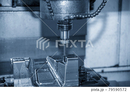 The CNC milling machine cutting the  mold parts with oil coolant method.  79590572