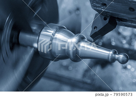 The  CNC lathe machine forming cut the metal shaft parts.  79590573
