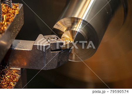 The close-up scene of lathe machine finish cut process the brass shaft material.  79590574