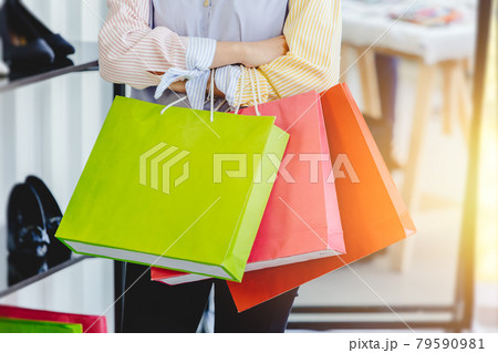 many shopping bag at fashion girl hand in shopping mall. many shopping bag at fashion girl hand in shopping mall. 79590981