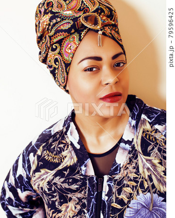young pretty african american woman isolated on white background happy smiling, wearing bright shawl and jewelry, lifestyle people concept close up young pretty african american woman isolated on white background happy smiling, wearing bright shawl and jewelry, lifestyle people concept close up 79596425