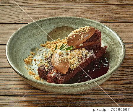 Chocolate cake with cream mousse, berry compote and nut crumbs Chocolate cake with cream mousse, berry compote and nut crumbs 79596697