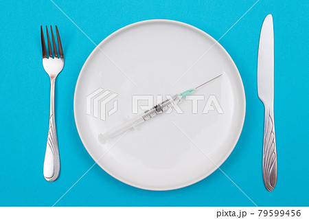 Medical Disposable Syringe on White Ceramic Plate Medical Disposable Syringe on White Ceramic Plate 79599456