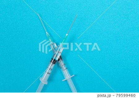 Vaccination or Revaccination Concept - Two Medical Syringe on Blue Table 79599460