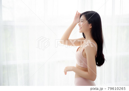 Beautiful portrait young asian woman sexy standing the window and smile while wake up with health. Beautiful portrait young asian woman sexy standing the window and smile while wake up with health. 79610265