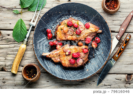 Grilled pork steaks with cherry sauce Grilled pork steaks with cherry sauce 79616046