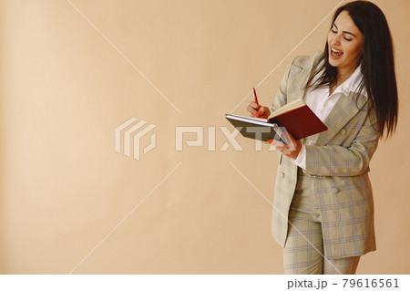 Woman standing on a brown background Woman standing on a brown background 79616561