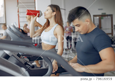 Young sports people training in a morning gym Young sports people training in a morning gym 79616959
