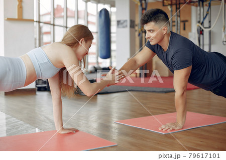 Young sports people training in a morning gym Young sports people training in a morning gym 79617101
