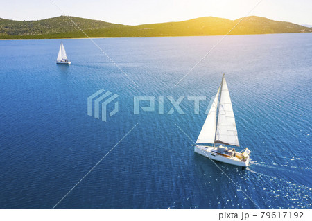 Yacht sailing at sunset during a storm. Luxury vacation at sea 79617192