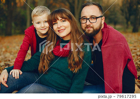 Family with little son in a autumn park Family with little son in a autumn park 79617295