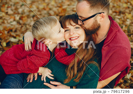 Family with little son in a autumn park Family with little son in a autumn park 79617296
