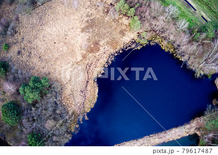 Aerial view, vertical down, of a blue lake in the heath Aerial view, vertical down, of a blue lake in the heath 79617487