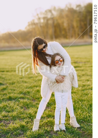 Elegant mother with daughter in a summer forest 79617510