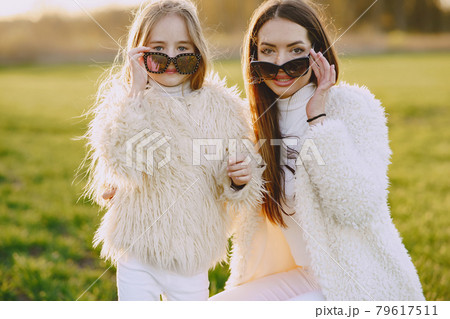 Elegant mother with daughter in a summer forest 79617511