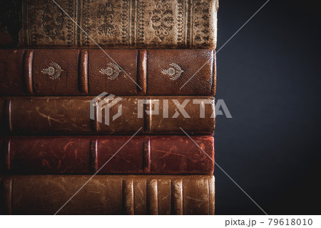 Stack of old books on black background Stack of old books on black background 79618010