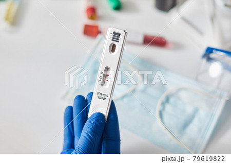 Doctor holding a test kit for viral disease coronavirus. Lab card kit test for COVID-19 2019-nCoV. Rapid test device virus 79619822