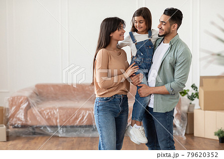 Happy family looking at each other, posing in new flat 79620352